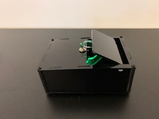 Figure2: The hook coming out of the box to flip the switch. Notice the green LED light